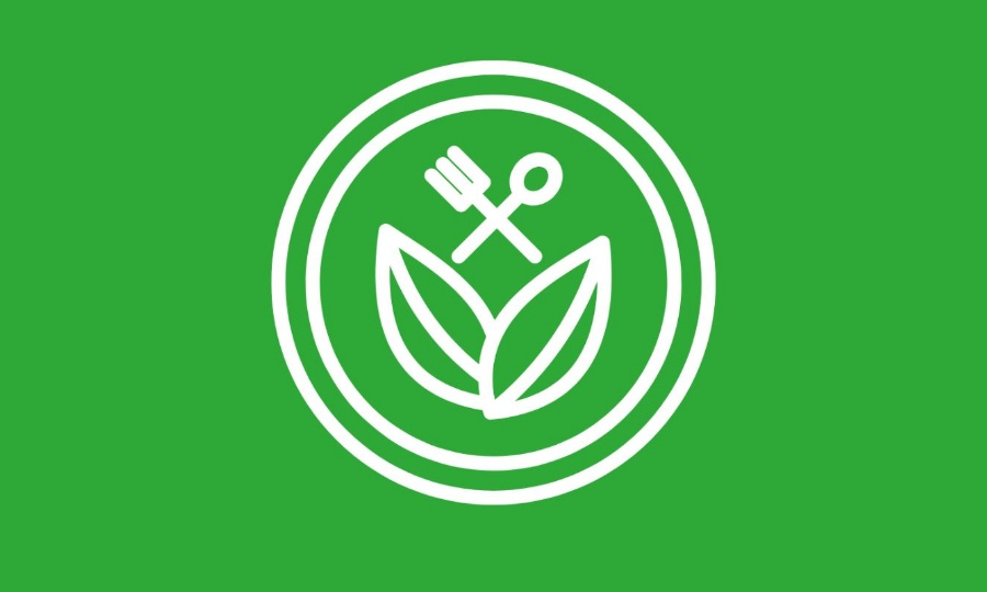 Green background with white icon of veganuary logo of leaves and cutlery